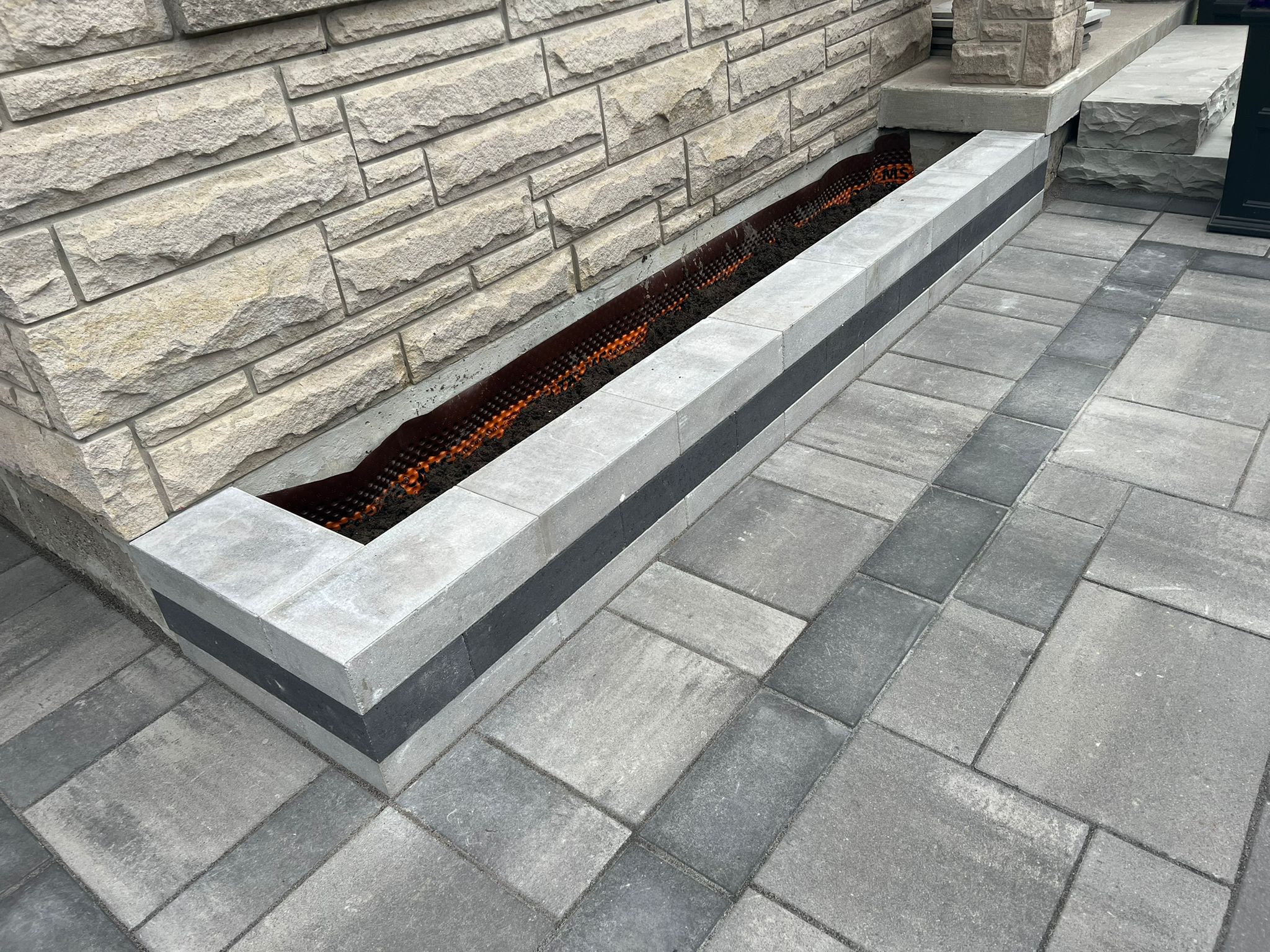 Stone planter and interlocking pavers